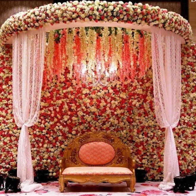 Floral wedding mandap with a gold sofa